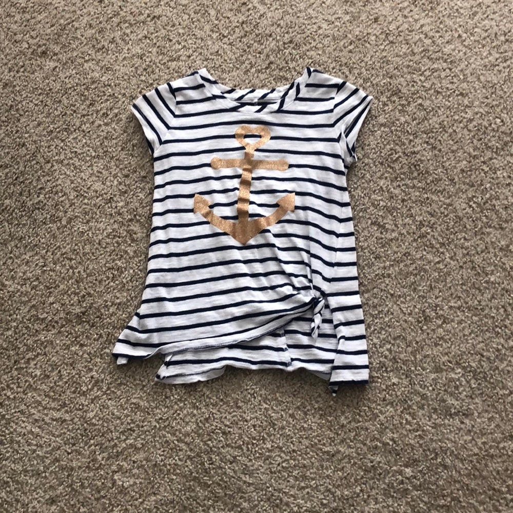 White shirt with blue stripes on it with an anchor
